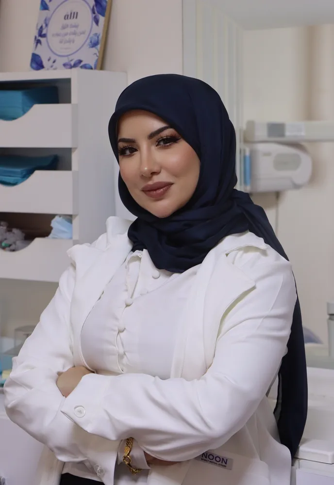 Dr. Racha Farhat, cosmetic dentist, standing in her dental clinic in Beirut
