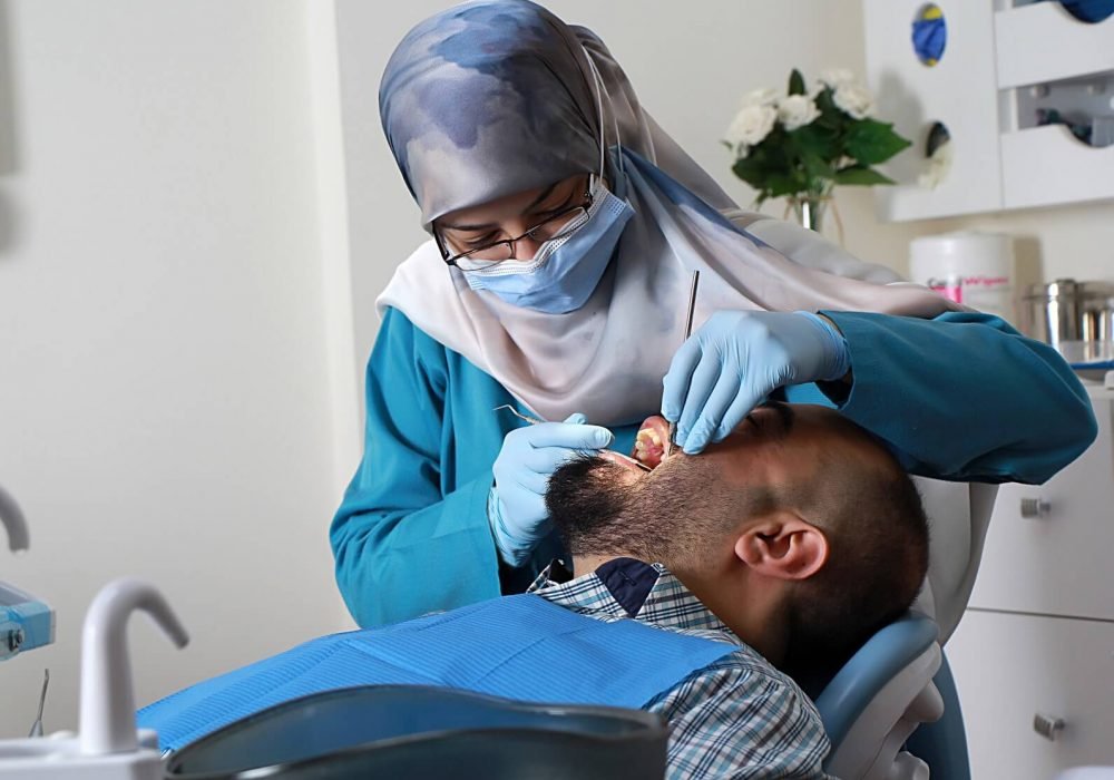Dr. Racha Farhat performing a dental procedure on a patient
